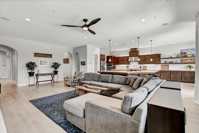2315 W Malone St, Hanford, CA 93230 - living area featuring arched walkways, a ceiling fan, light wood finished floors, and recessed lighting