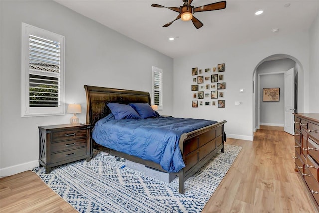 2315 W Malone St, Hanford, CA 93230 - bedroom featuring arched walkways, multiple windows, light wood finished floors, baseboards, and recessed lighting