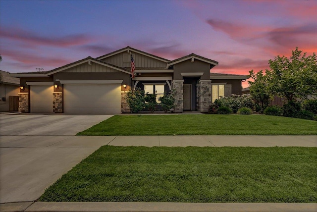 2315 W Malone St, Hanford, CA 93230 - view of front of house with stone siding, an attached garage, concrete driveway, and a lawn