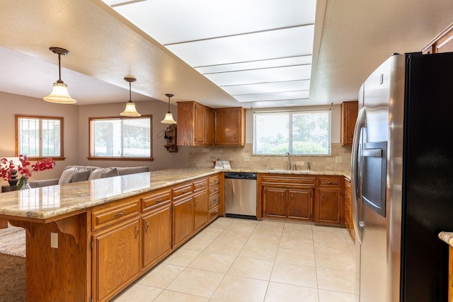 16895 Rd 30 1/2, Madera, CA 93636 - kitchen with stainless steel appliances, a sink, brown cabinetry, and a peninsula