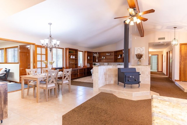 16895 Rd 30 1/2, Madera, CA 93636 - dining space with vaulted ceiling, light tile patterned flooring, a chandelier, a ceiling fan, and a wood stove