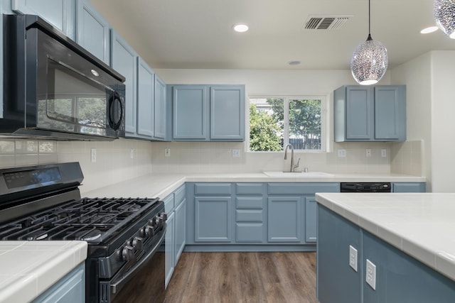798 S Burgan Ave, Fresno, CA 93727 - kitchen featuring black appliances, blue cabinets, a sink, tile countertops, and dark wood finished floors