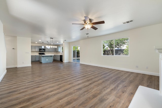 798 S Burgan Ave, Fresno, CA 93727 - unfurnished living room with dark wood-style floors, baseboards, ceiling fan, recessed lighting, and plenty of natural light