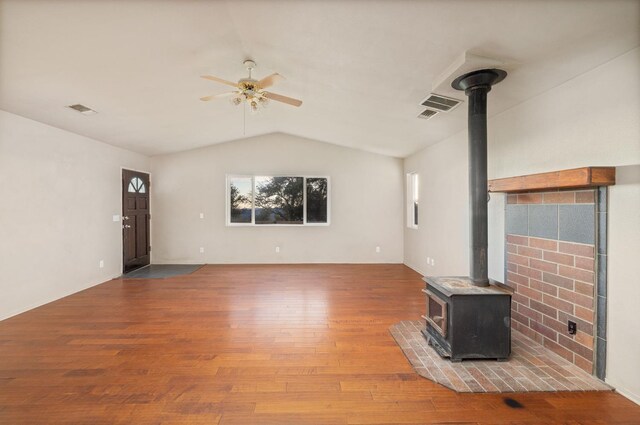 5664 Clouds Rst, Mariposa, CA 95338 - unfurnished living room featuring a wood stove, a ceiling fan, vaulted ceiling, and wood finished floors