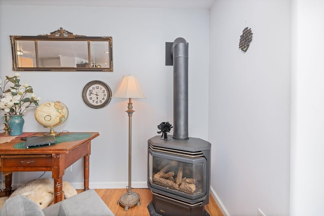 5664 Clouds Rst, Mariposa, CA 95338 - detailed view of a wood stove, wood finished floors, and baseboards