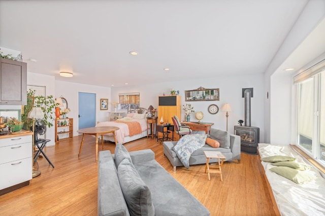 5664 Clouds Rst, Mariposa, CA 95338 - bedroom featuring a wood stove and light wood-style floors
