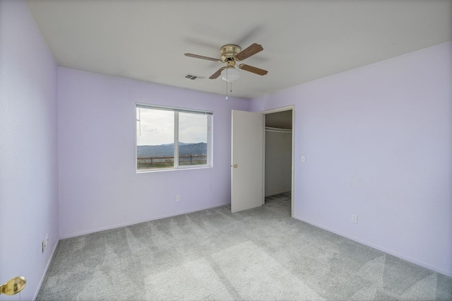 5664 Clouds Rst, Mariposa, CA 95338 - unfurnished bedroom featuring carpet flooring, a ceiling fan, a walk in closet, and baseboards