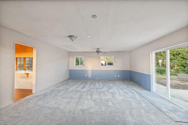 5664 Clouds Rst, Mariposa, CA 95338 - carpeted empty room featuring healthy amount of natural light, wainscoting, and a ceiling fan