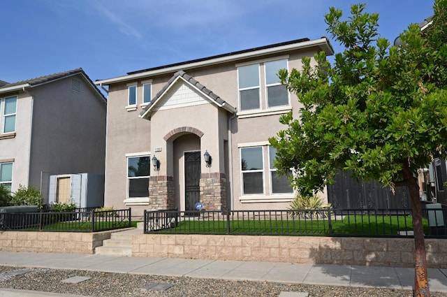 11332 N Cherry Sage Ave, Fresno, CA 93730 - multi unit property featuring stucco siding, a fenced front yard, and stone siding