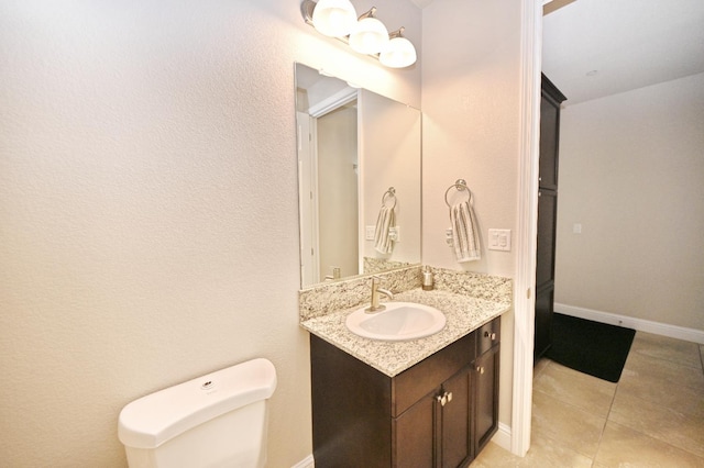 11332 N Cherry Sage Ave, Fresno, CA 93730 - bathroom with vanity, toilet, tile patterned flooring, and baseboards