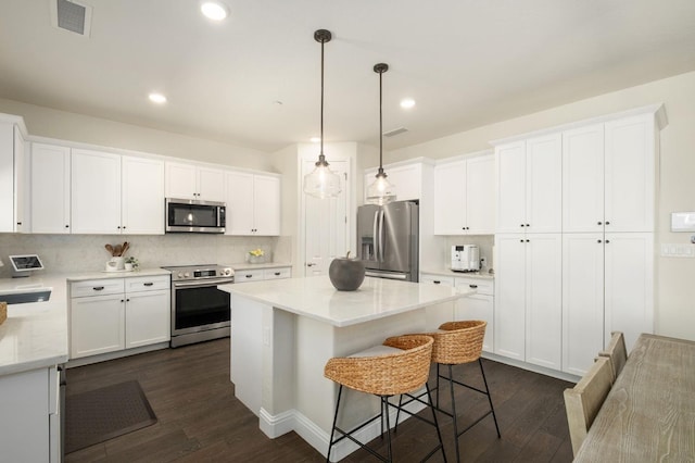 1362 E Via Viola Way, Fresno, CA 93730 - kitchen featuring stainless steel appliances, dark wood-type flooring, white cabinets, and recessed lighting