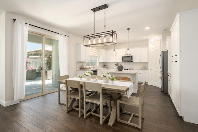 1362 E Via Viola Way, Fresno, CA 93730 - dining room with dark wood-style flooring, recessed lighting, and baseboards