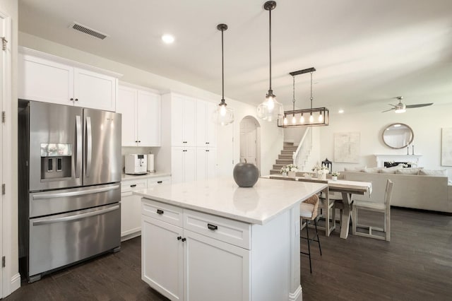 1362 E Via Viola Way, Fresno, CA 93730 - kitchen with stainless steel fridge, a kitchen island, white cabinets, a ceiling fan, and dark wood-type flooring