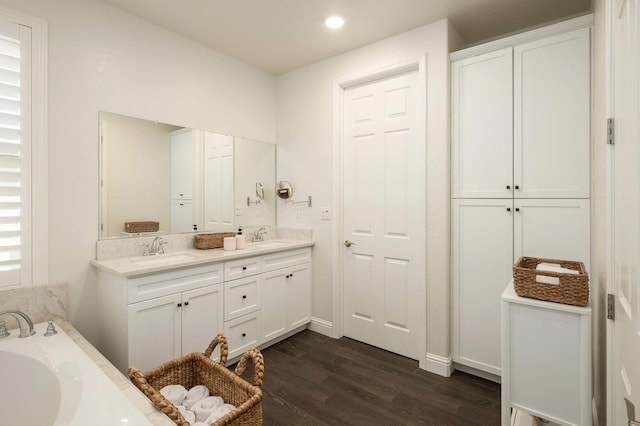 1362 E Via Viola Way, Fresno, CA 93730 - full bathroom featuring wood finished floors, double vanity, a bath, recessed lighting, and baseboards