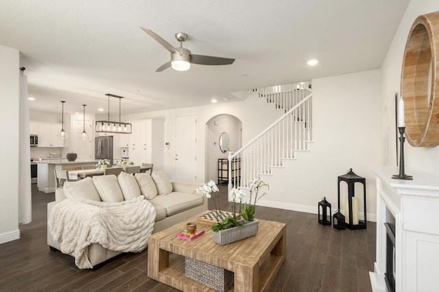 1362 E Via Viola Way, Fresno, CA 93730 - living room with recessed lighting, a ceiling fan, dark wood finished floors, stairs, and arched walkways