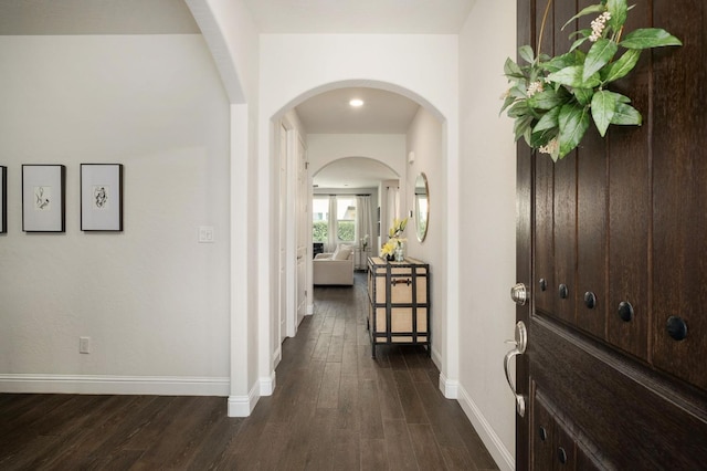 1362 E Via Viola Way, Fresno, CA 93730 - hall featuring baseboards, dark wood-style floors, and arched walkways