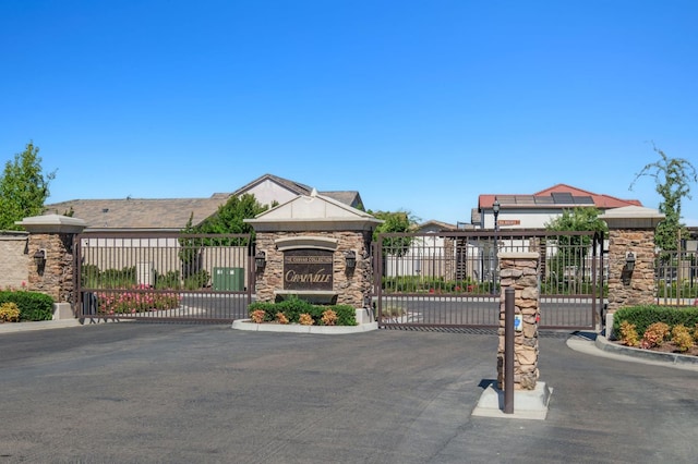 1362 E Via Viola Way, Fresno, CA 93730 - view of asphalt road with a gate, a gated entry, and curbs