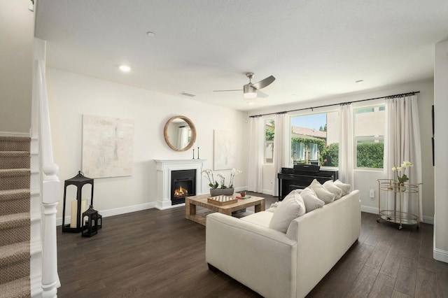 1362 E Via Viola Way, Fresno, CA 93730 - living room featuring dark wood-type flooring, stairway, a ceiling fan, baseboards, and a glass covered fireplace