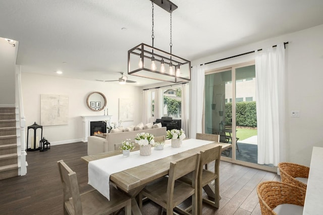 1362 E Via Viola Way, Fresno, CA 93730 - dining space with wood finished floors, a glass covered fireplace, a ceiling fan, stairway, and recessed lighting