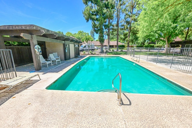 community pool with fence and a patio