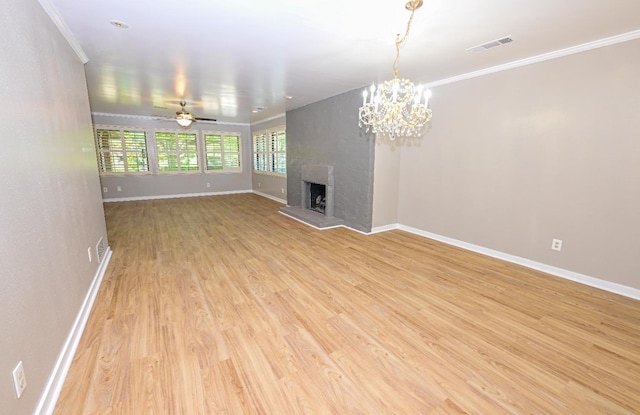5088 N Forkner Ave, Fresno, CA 93711 - unfurnished living room with light wood-style floors, a large fireplace, crown molding, a chandelier, and a ceiling fan