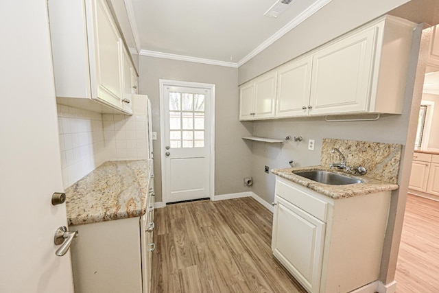 5088 N Forkner Ave, Fresno, CA 93711 - laundry room with cabinet space, light wood finished floors, ornamental molding, hookup for a washing machine, and hookup for an electric dryer
