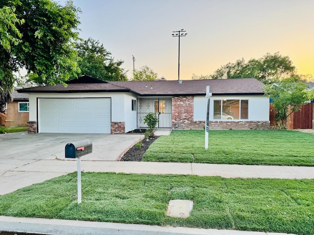 2332 S Jackson Ave, Fresno, CA 93725 - single story home featuring driveway, an attached garage, brick siding, and roof with shingles