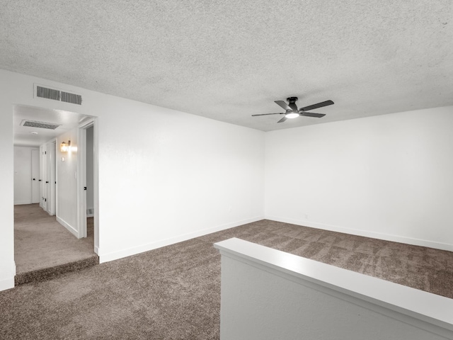 2332 S Jackson Ave, Fresno, CA 93725 - spare room featuring carpet flooring, ceiling fan, a textured ceiling, and baseboards