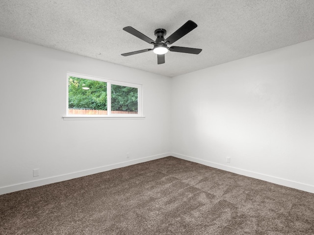 2332 S Jackson Ave, Fresno, CA 93725 - spare room with a textured ceiling, dark colored carpet, a ceiling fan, and baseboards