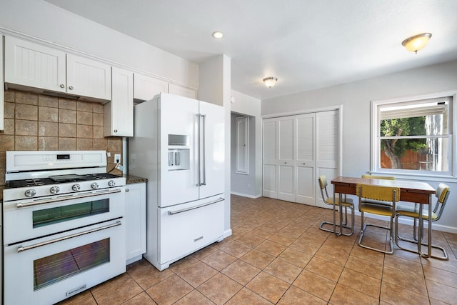 kitchen featuring white appliances, tasteful backsplash, white cabinets, light tile patterned floors, and recessed lighting