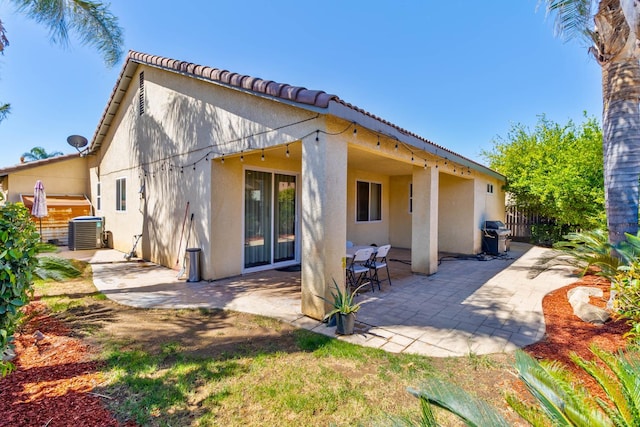 5179 E Lyell Ave, Fresno, CA 93727 - rear view of property featuring stucco siding, cooling unit, and a patio