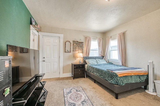 4487 E Bend Ave, Fresno, CA 93702 - bedroom with a textured ceiling, light carpet, a textured wall, and baseboards