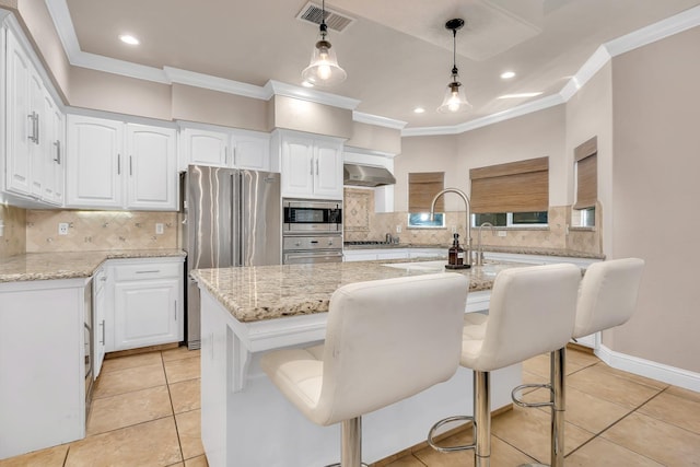 10717 N Bunkerhill Dr, Fresno, CA 93730 - kitchen featuring stainless steel appliances, crown molding, tasteful backsplash, white cabinetry, and light stone countertops