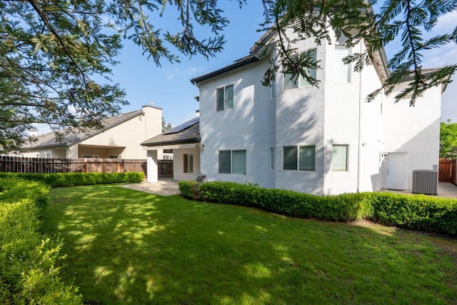 10717 N Bunkerhill Dr, Fresno, CA 93730 - back of property with central AC, stucco siding, and a patio