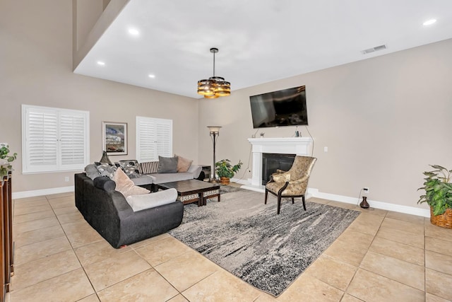 10717 N Bunkerhill Dr, Fresno, CA 93730 - tiled living room with recessed lighting, baseboards, and a glass covered fireplace