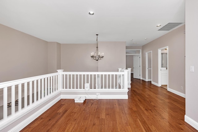 10717 N Bunkerhill Dr, Fresno, CA 93730 - empty room featuring wood finished floors, a chandelier, baseboards, and recessed lighting