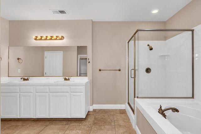10717 N Bunkerhill Dr, Fresno, CA 93730 - full bathroom with a shower stall, double vanity, a relaxing tiled tub, baseboards, and tile patterned flooring