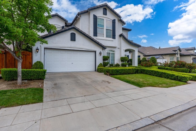 10717 N Bunkerhill Dr, Fresno, CA 93730 - traditional home with stucco siding, driveway, and a tiled roof