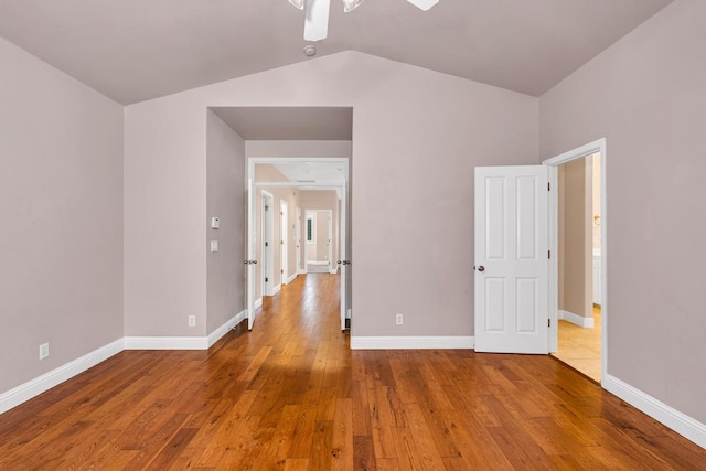 10717 N Bunkerhill Dr, Fresno, CA 93730 - unfurnished room featuring ceiling fan, wood-type flooring, lofted ceiling, and baseboards