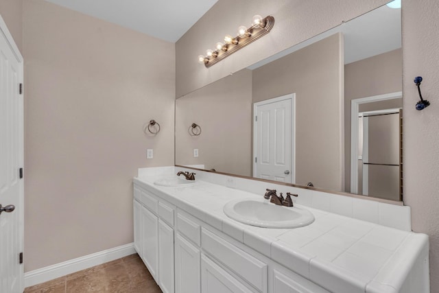 10717 N Bunkerhill Dr, Fresno, CA 93730 - full bathroom with double vanity, baseboards, and a shower with door