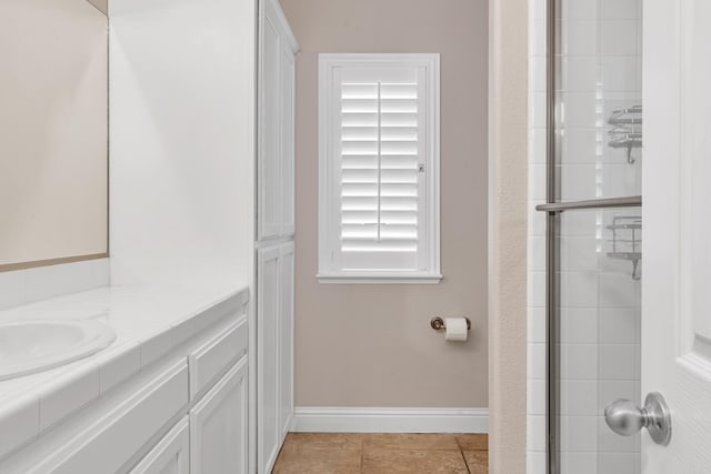 10717 N Bunkerhill Dr, Fresno, CA 93730 - full bathroom featuring baseboards, a tile shower, vanity, and tile patterned floors
