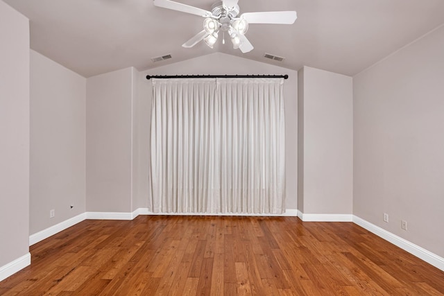 10717 N Bunkerhill Dr, Fresno, CA 93730 - spare room with ceiling fan, hardwood / wood-style floors, vaulted ceiling, and baseboards