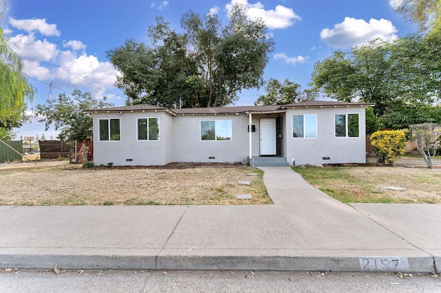 2157 Locust St, Selma, CA 93662 - view of front facade featuring crawl space, stucco siding, and fence