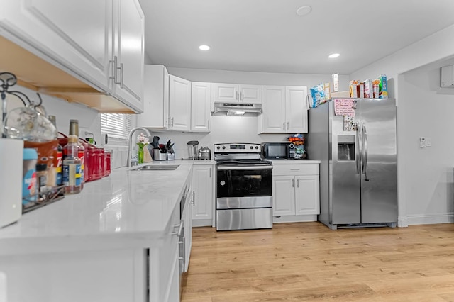 2157 Locust St, Selma, CA 93662 - kitchen with appliances with stainless steel finishes, a sink, under cabinet range hood, white cabinets, and light countertops