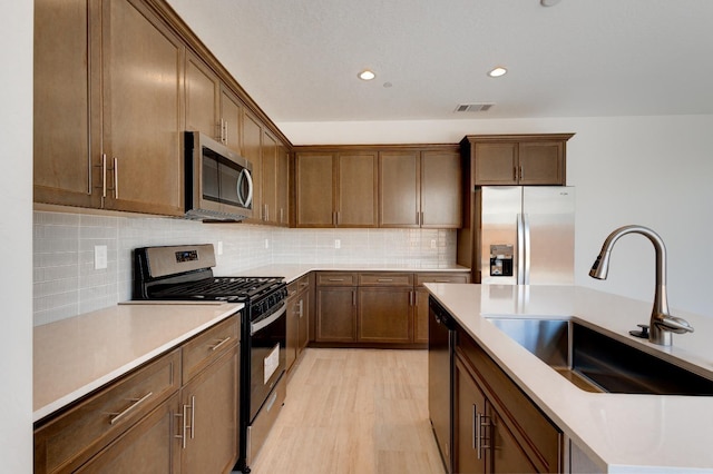 495 Thunder Rd S, Madera, CA 93636 - kitchen featuring stainless steel appliances, a sink, light countertops, recessed lighting, and backsplash