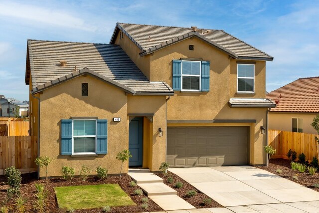 495 Thunder Rd S, Madera, CA 93636 - view of front facade with stucco siding, fence, an attached garage, concrete driveway, and a tile roof