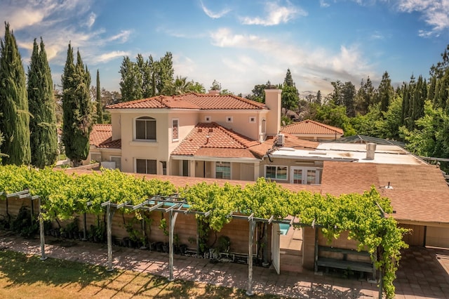 8067 E Belmont Ave, Fresno, CA 93737 - rear view of property with a chimney, a tile roof, a patio, a garden, and stucco siding