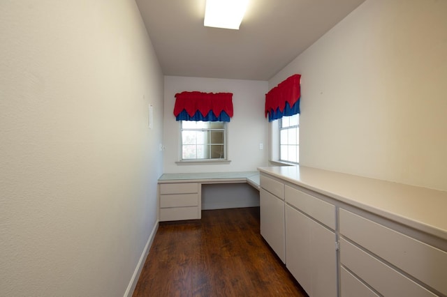 8067 E Belmont Ave, Fresno, CA 93737 - unfurnished office with built in study area, dark wood-type flooring, and baseboards