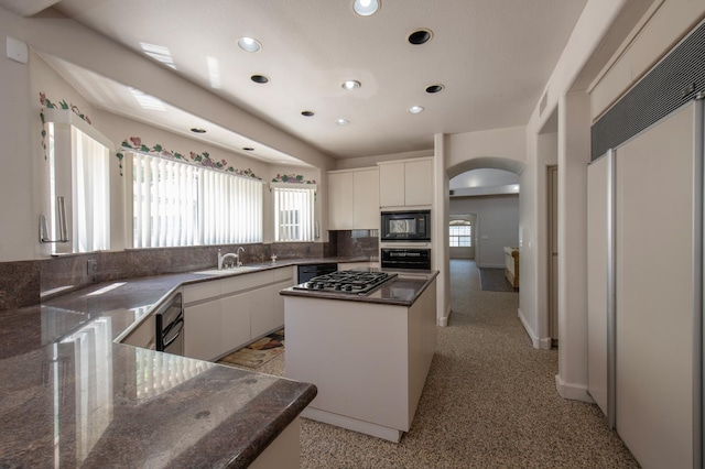 8067 E Belmont Ave, Fresno, CA 93737 - kitchen with black appliances, arched walkways, a sink, recessed lighting, and white cabinets
