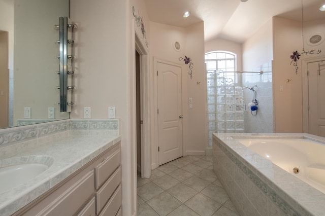 8067 E Belmont Ave, Fresno, CA 93737 - bathroom with tile patterned flooring, vaulted ceiling, tiled shower, tiled bath, and vanity